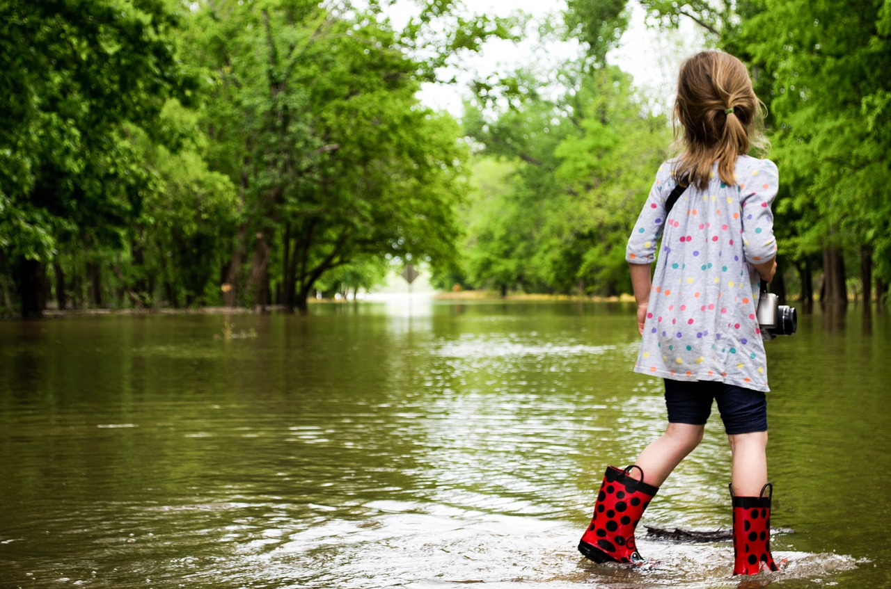 girl walking in floodwaters